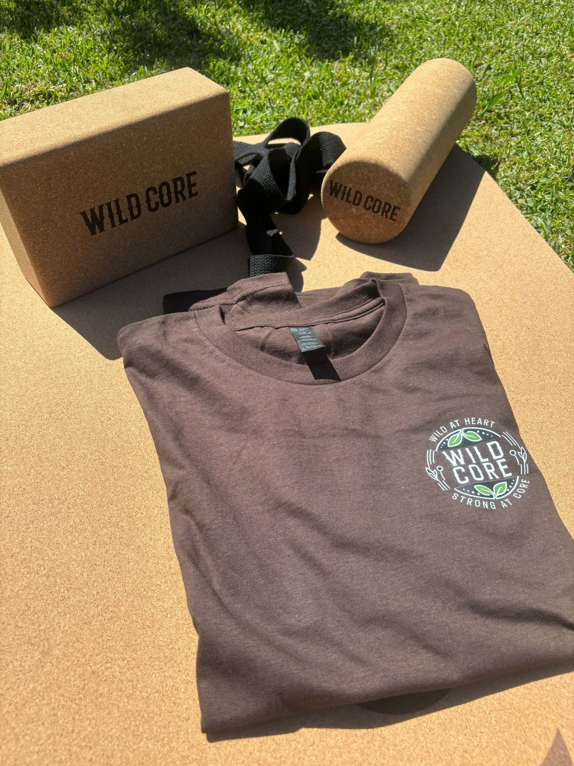 Wild Core Full Set featuring eco-friendly premium cork yoga mat, cork massage roller, cork yoga block, and organic cotton t-shirt on grass background