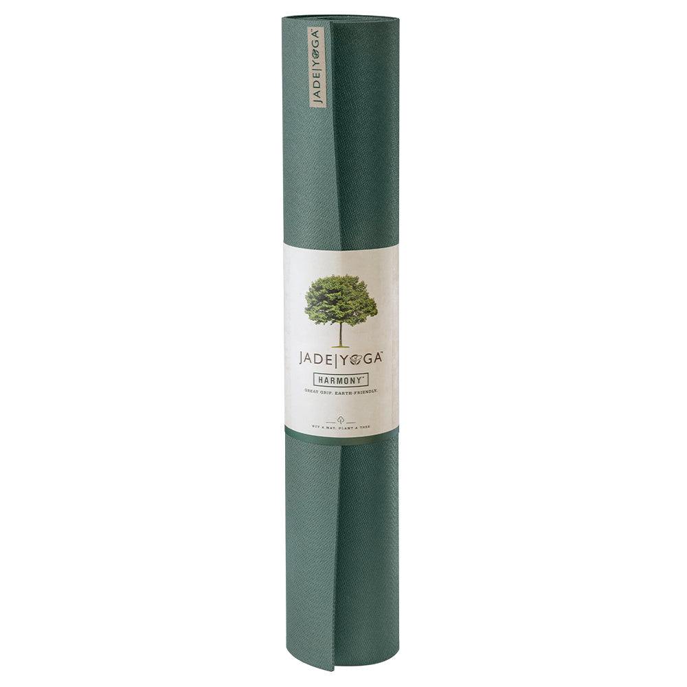 Rolled Jade Yoga Harmony Mat in jade green made of non-toxic natural rubber with firm grip and cushioning for stability and comfort.