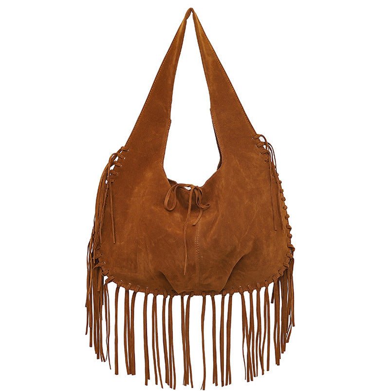 Brown bohemian style fringed hobo bag made of soft faux suede with a spacious shoulder tote design and decorative tie closure.