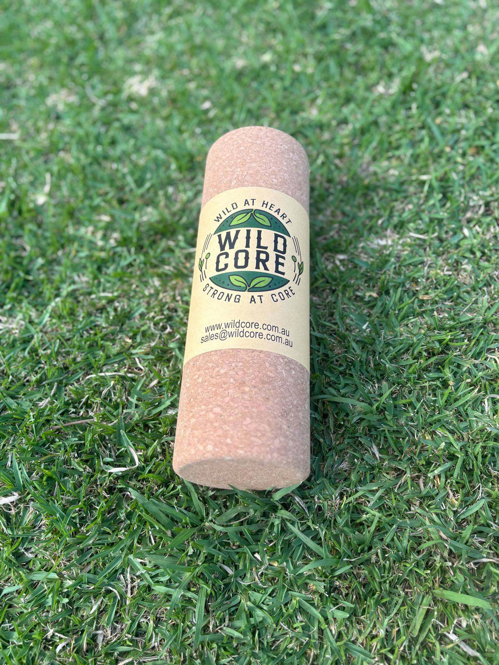 Wild Core premium cork massage roller on grass for deep-tissue muscle relief and sustainable recovery
