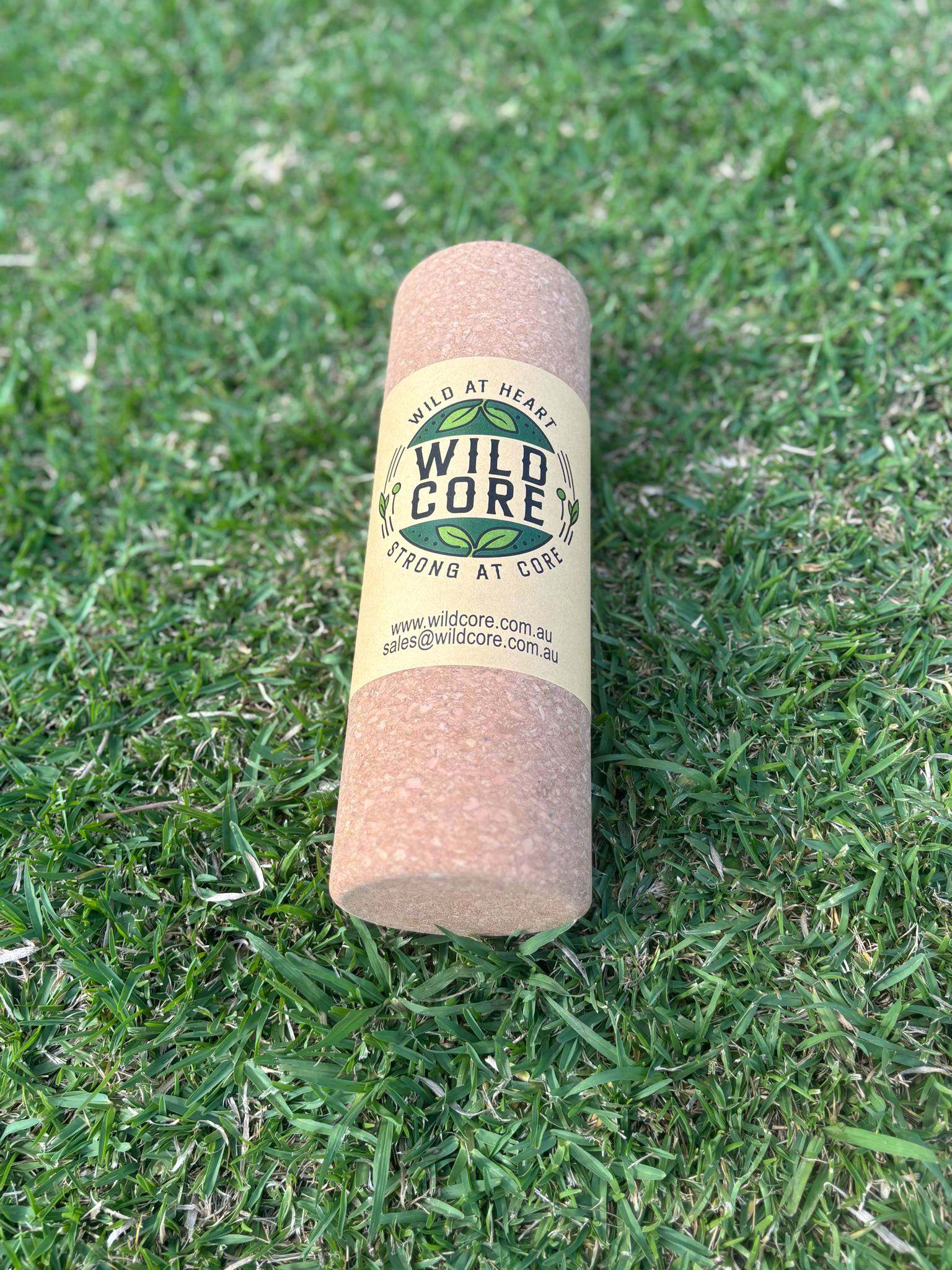 Wild Core premium cork massage roller on grass for deep-tissue muscle relief and sustainable recovery