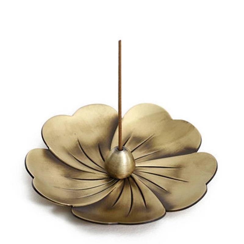 Vintage alloy incense burner shaped like a bronze flower with a central holder for sandalwood incense sticks.