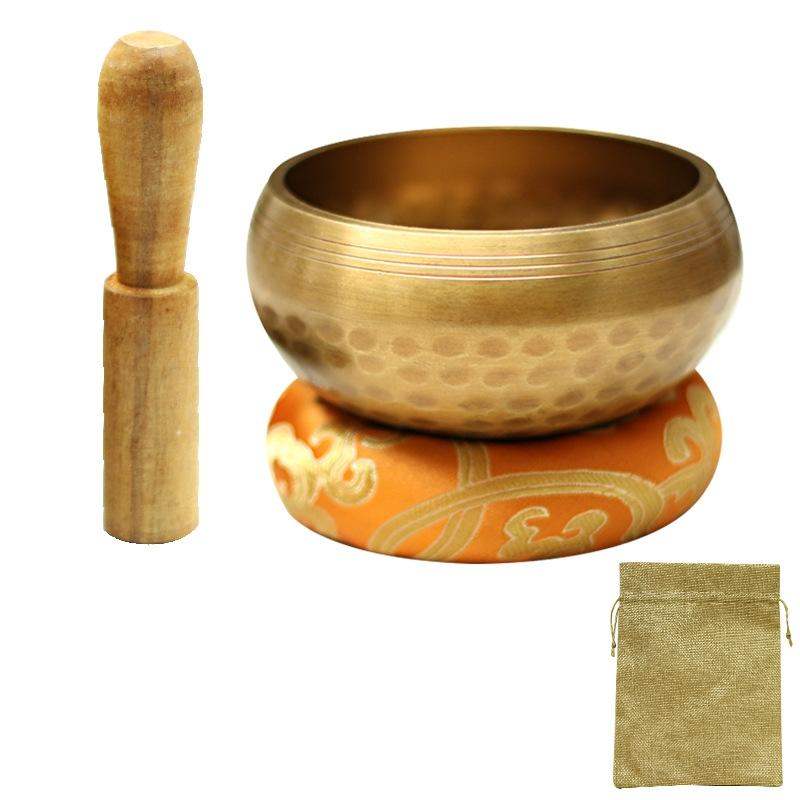 8.5cm copper Buddha sound bowl set with wooden stick, decorative mat, and linen bag for meditation and yoga.