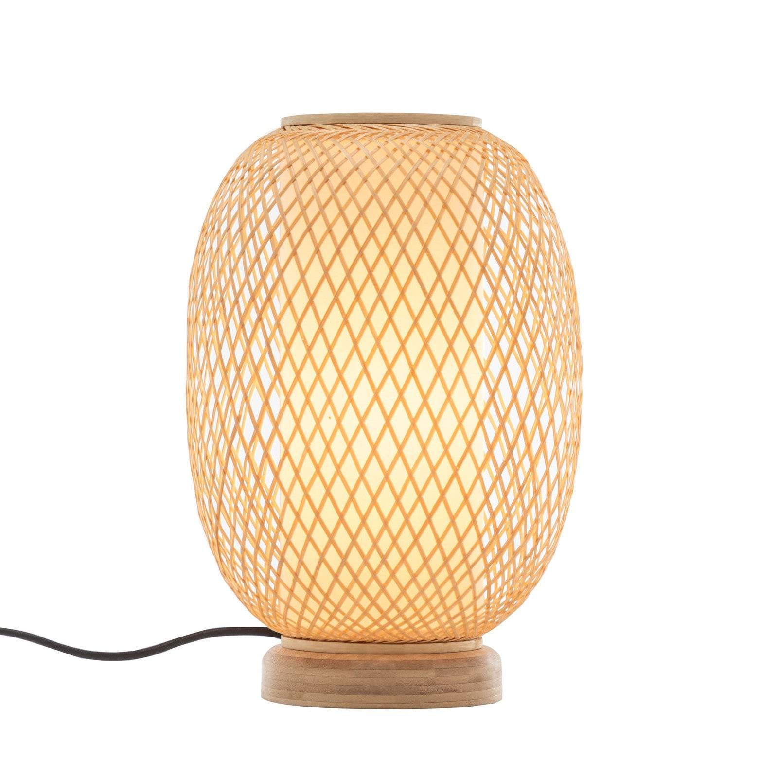 Natural woven bamboo oval table lamp with rattan shade and wooden base emitting warm light