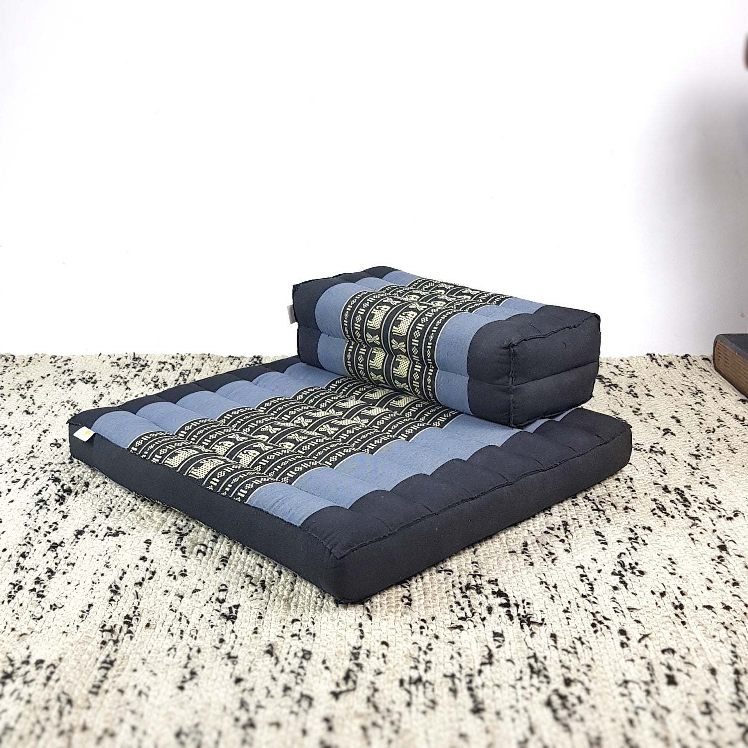 Blue elephant patterned meditation cushion and seating block set made of handmade cotton with organic kapok filling on a textured rug