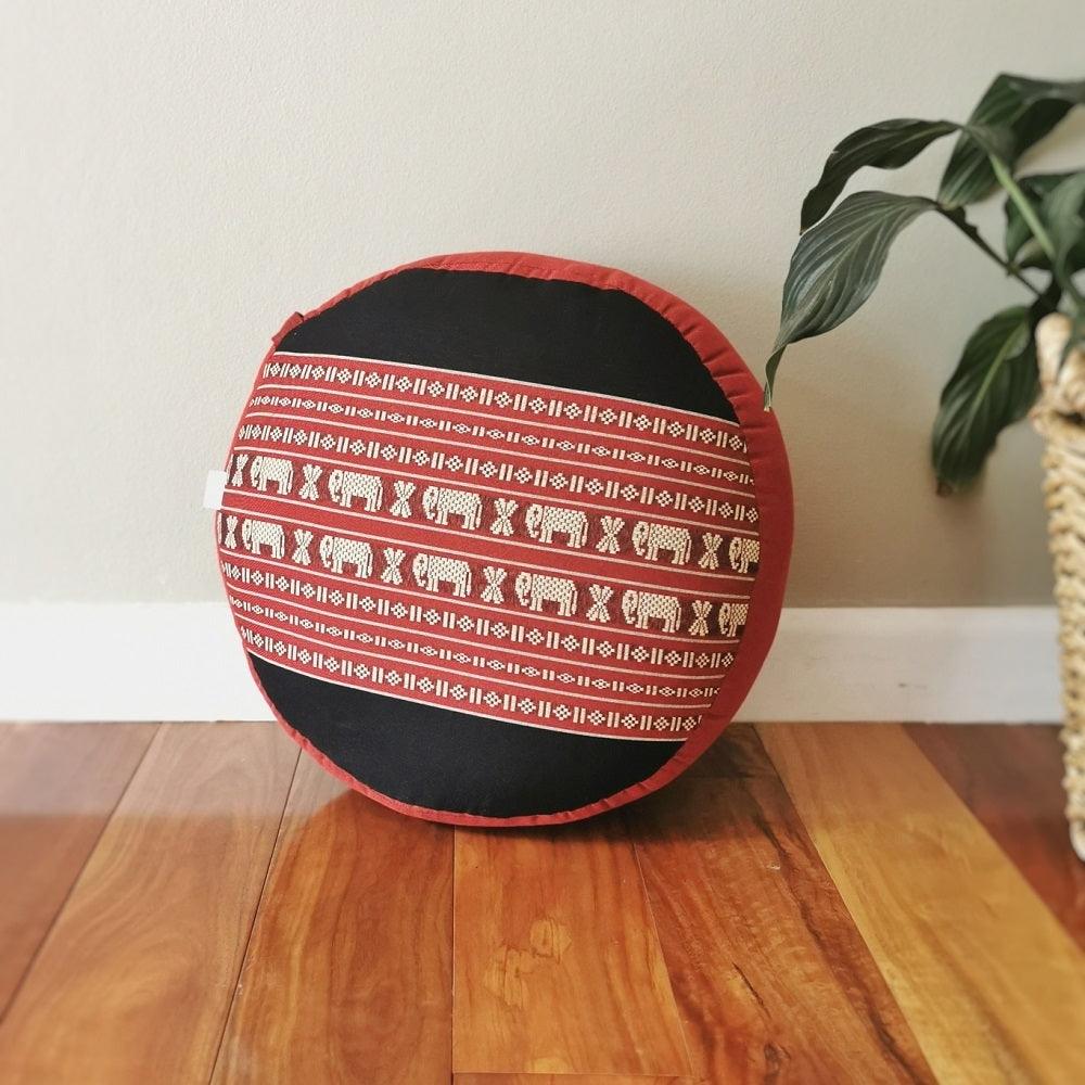 40cm round red meditation cushion with elephant pattern filled with organic kapok on wooden floor next to green plant