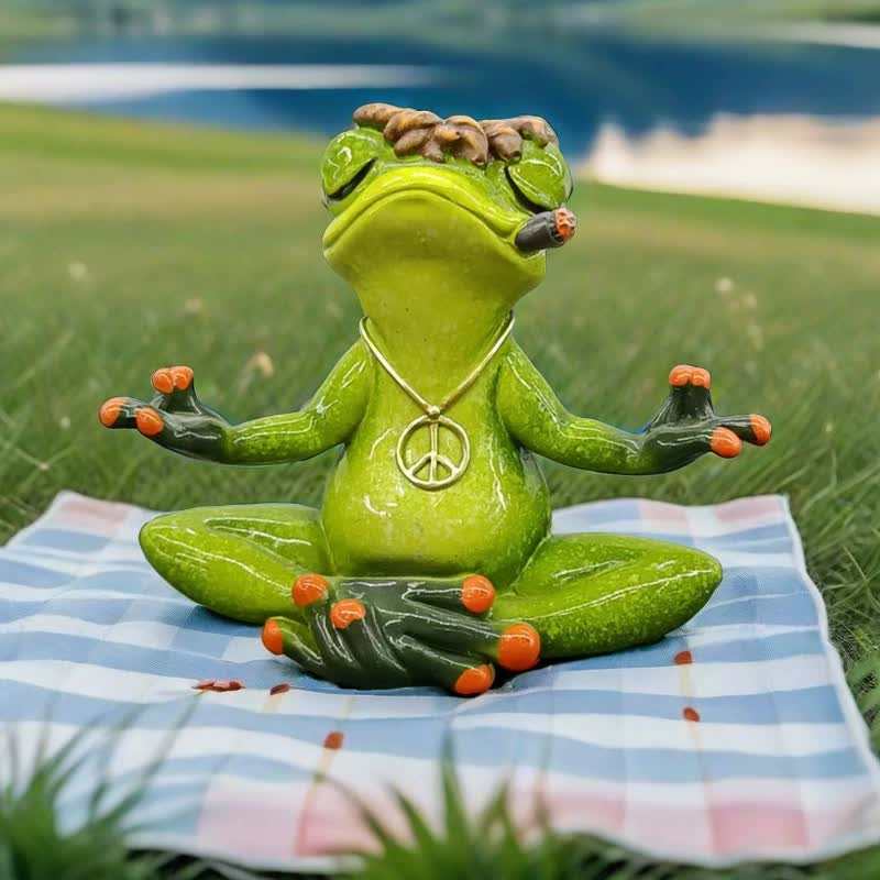 Green Zen Frog Meditation Figurine in yoga pose with peace sign necklace and cigar on checkered mat outdoors