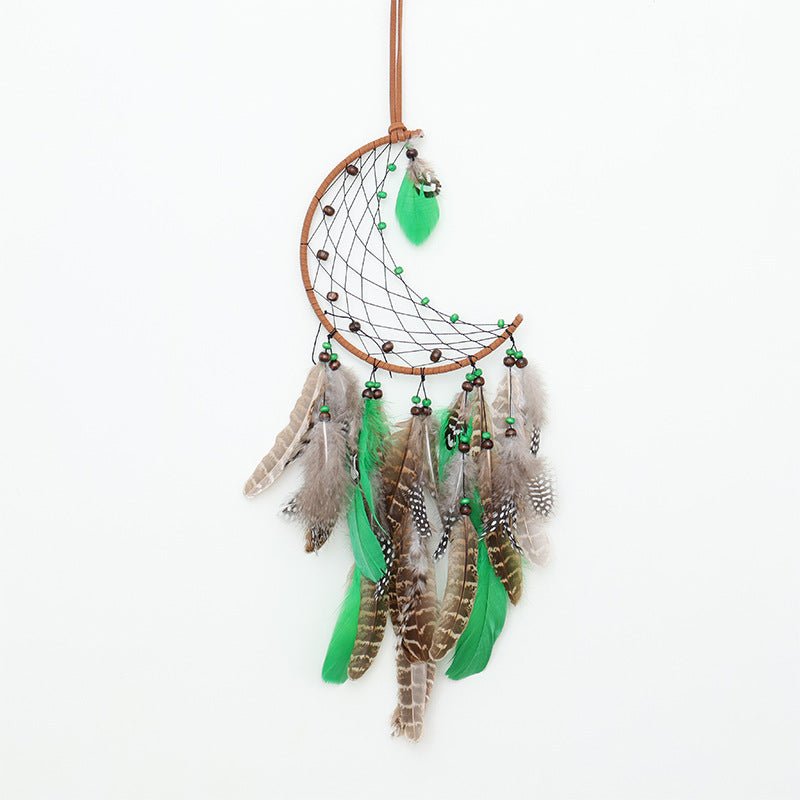 Crescent Boho Forest Dreamcatcher with green and brown feathers and beaded wind chimes hanging on white background