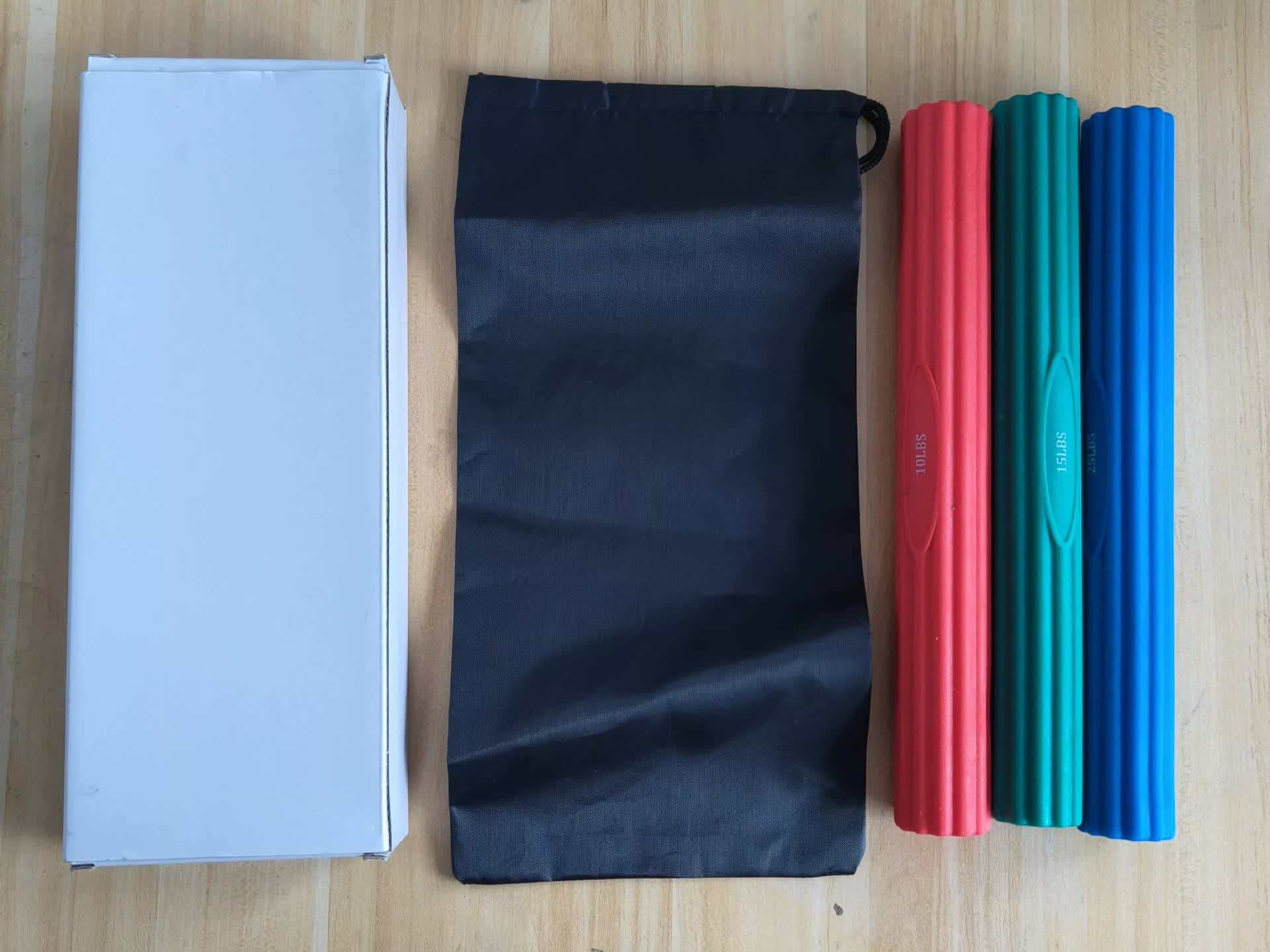 Multifunctional resistance bar set with three colorful silicone bars, black storage bag, and white packaging box for fitness and muscle recovery.