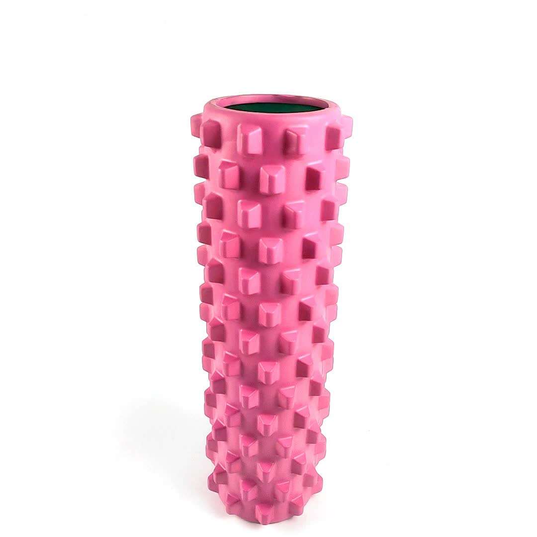 Rose red solid yoga foam roller with textured wolf tooth design for muscle relaxation and massage
