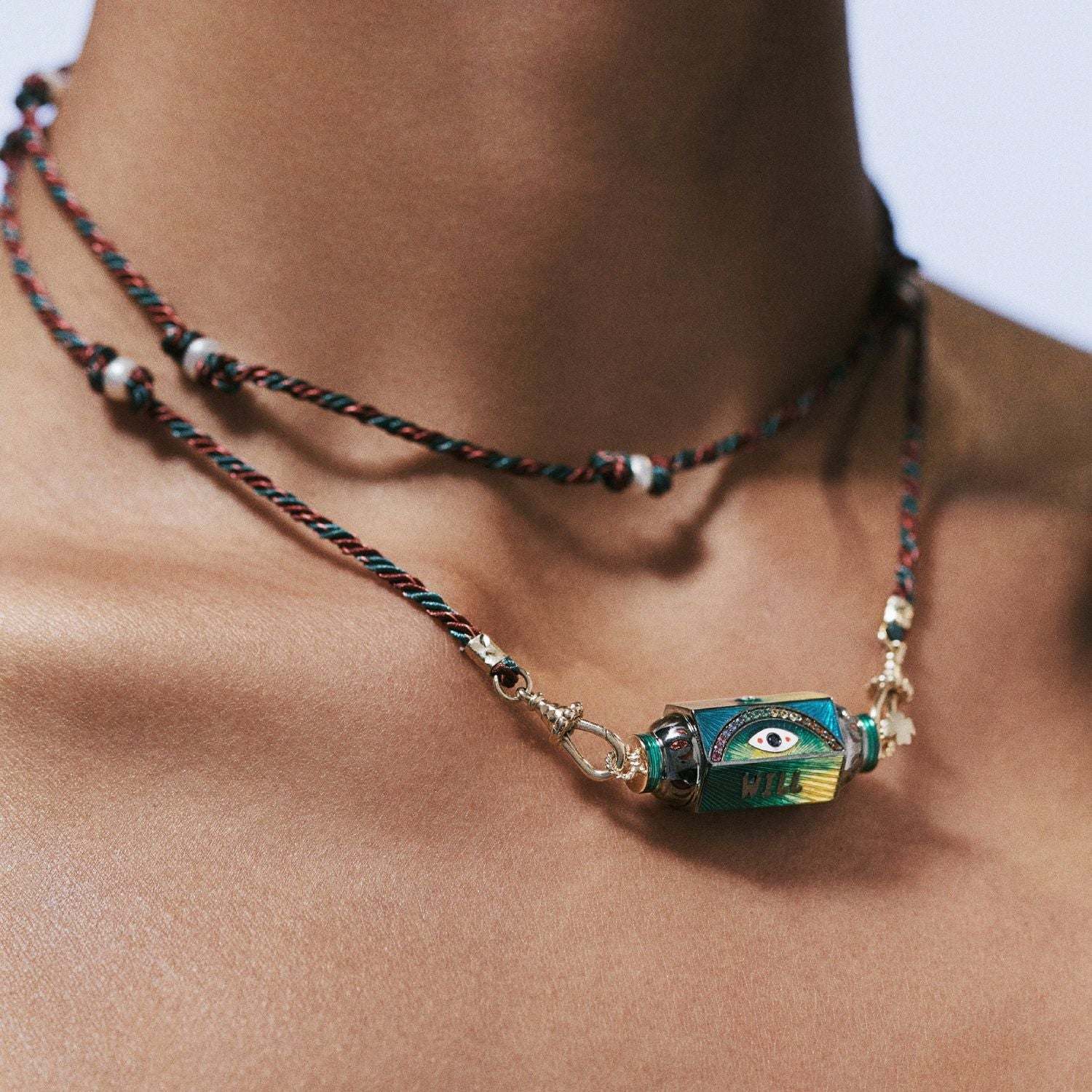 Mystical Tarot Charm Necklace with green eye pendant on a boho multicolored cord chain.