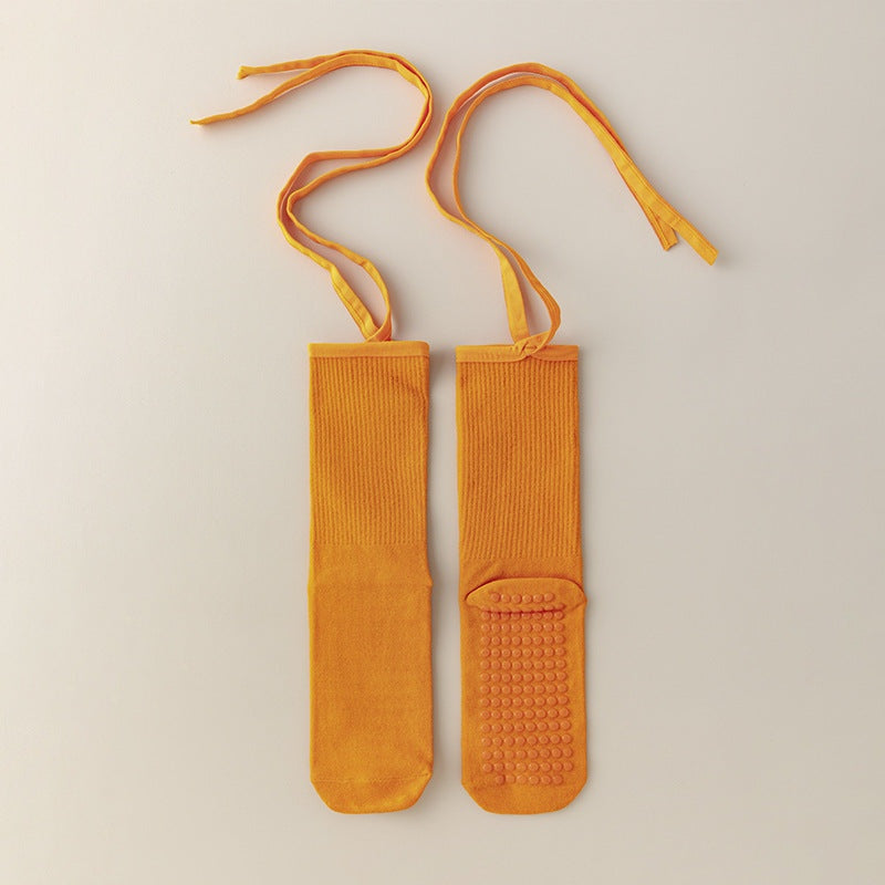 Set of 3 orange non-slip yoga socks with cross straps, made of lightweight breathable cotton, featuring silicone grip soles for women’s Pilates and dance.