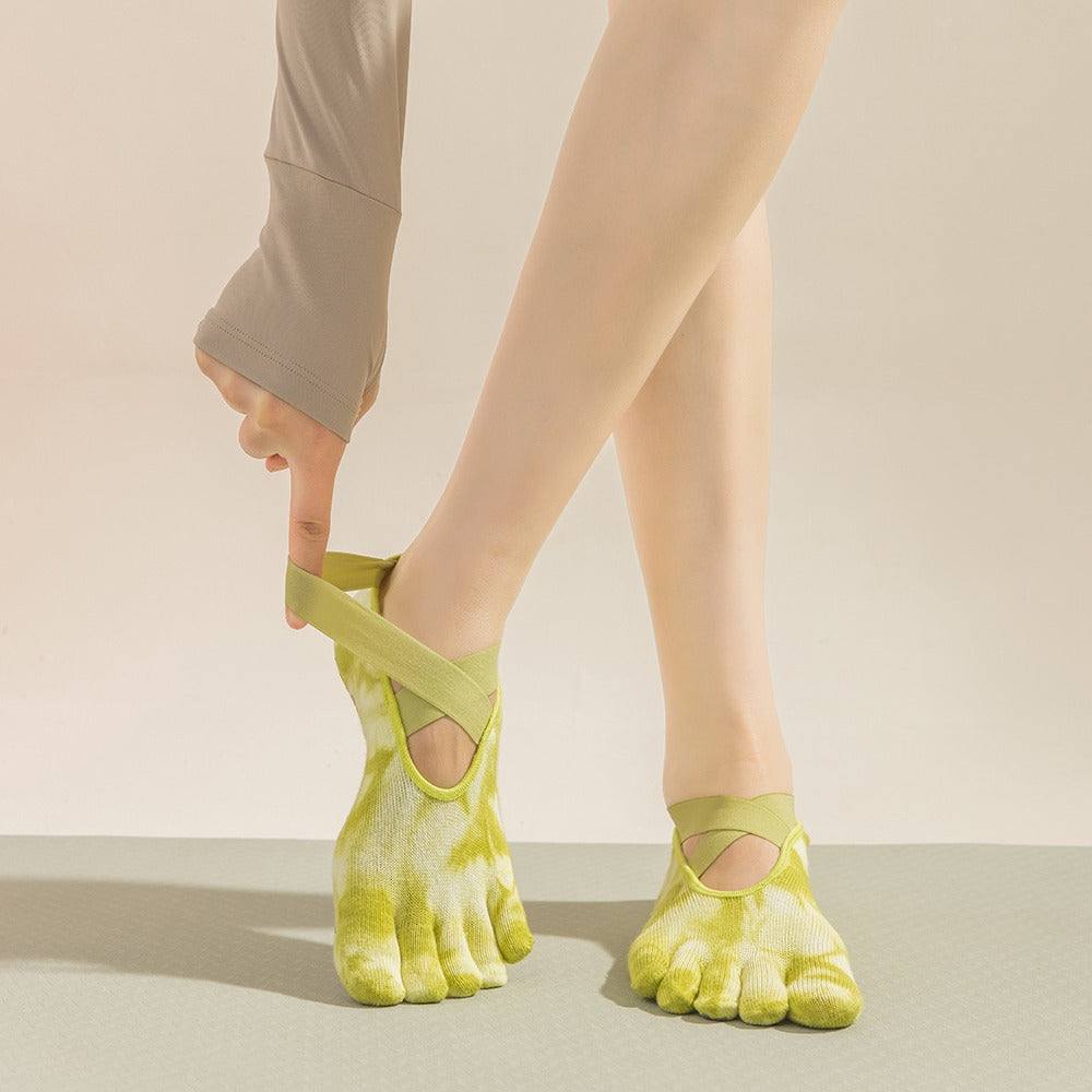 Pair of women's light green tie-dye five-toe non-slip yoga socks with cotton blend material for Pilates and indoor sports