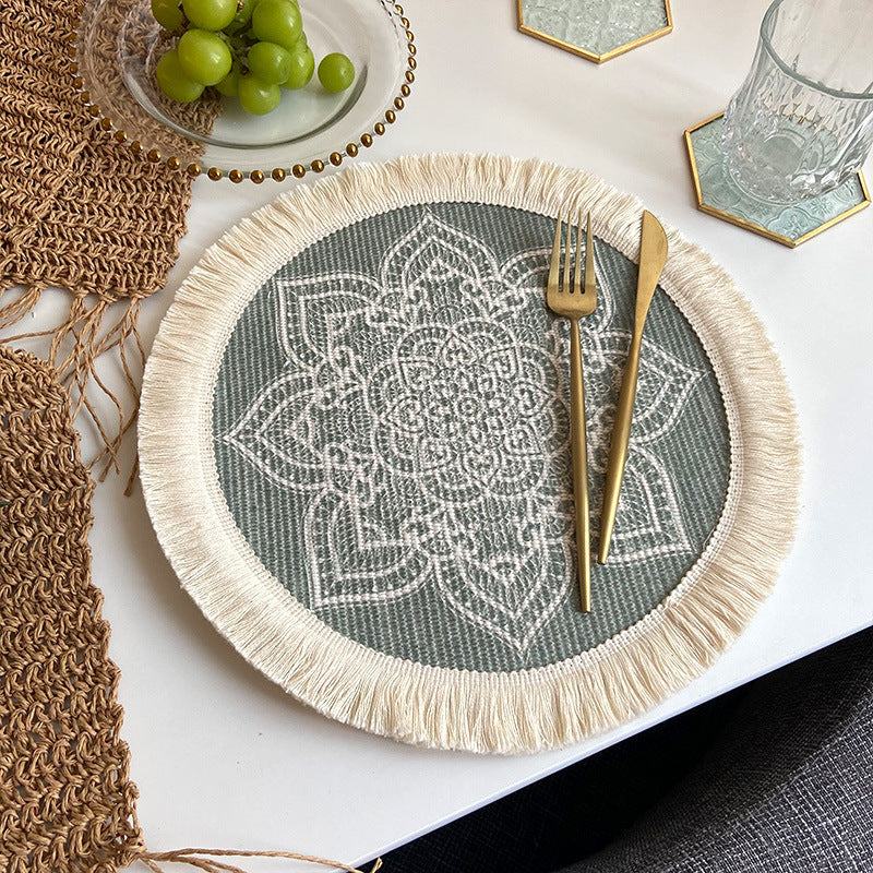 Boho chic woven cotton placemat in beige and grey with mandala design and tassels on white table setting