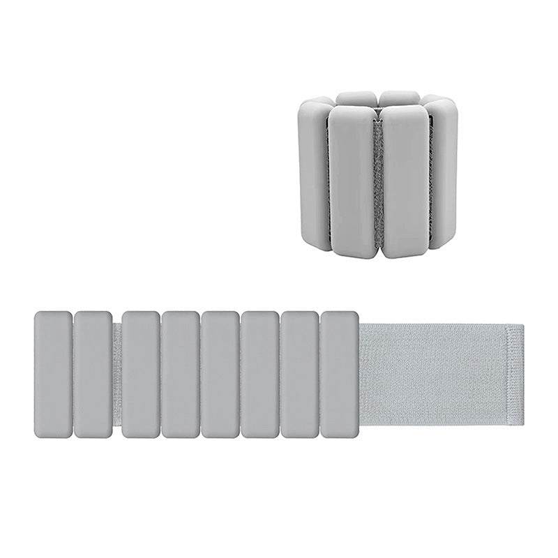 Grey adjustable silicone wrist and ankle weights with removable steel blocks and Velcro strap for fitness workouts