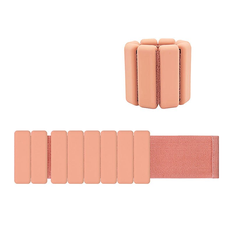 Light orange premium adjustable silicone wrist and ankle weight with removable steel blocks and Velcro strap for fitness workouts.